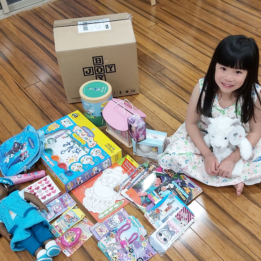 Girl with CaringKids Toy Box