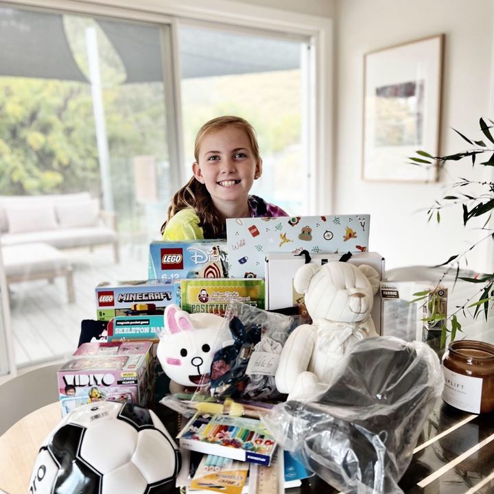Young carer Laura with toys from Joy Box